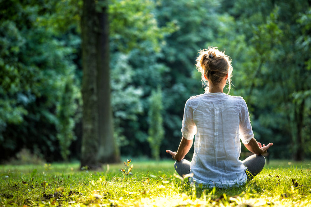 woman-meditating-in-the-forest