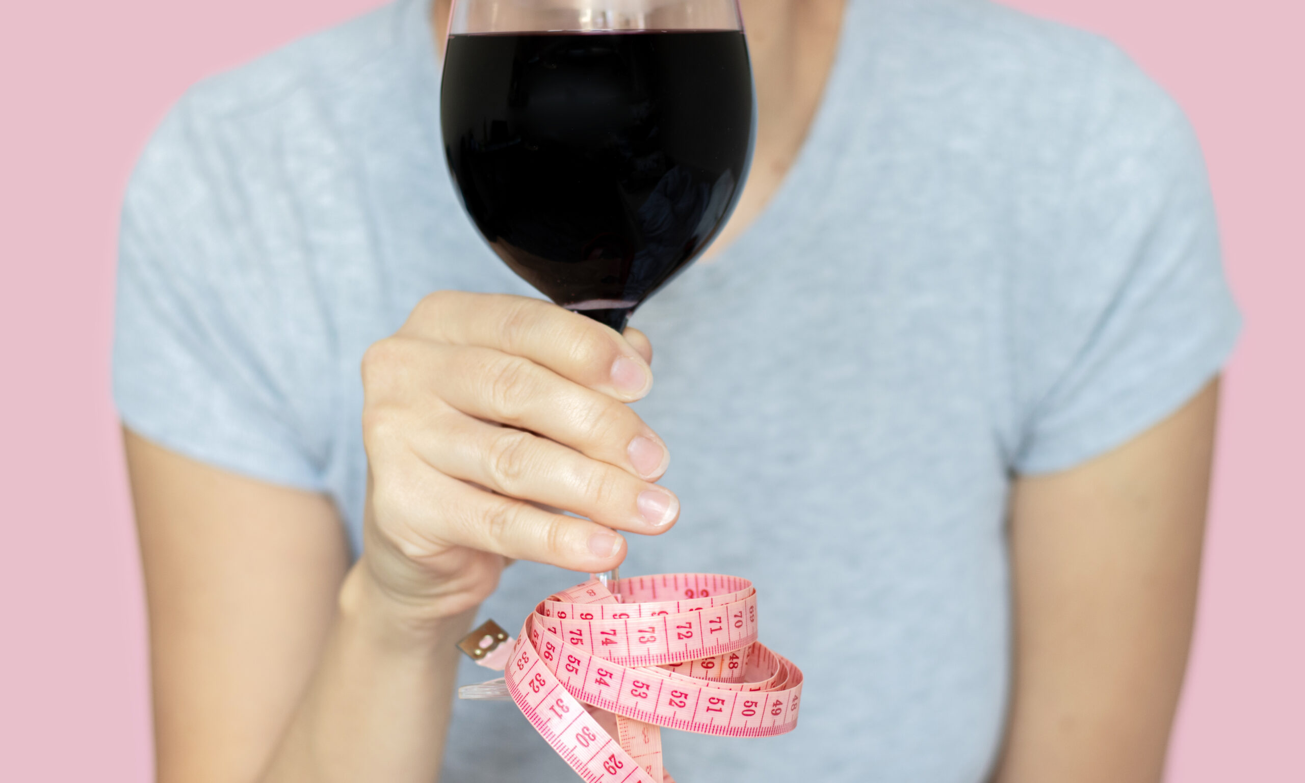 woman holding a glass of red wine