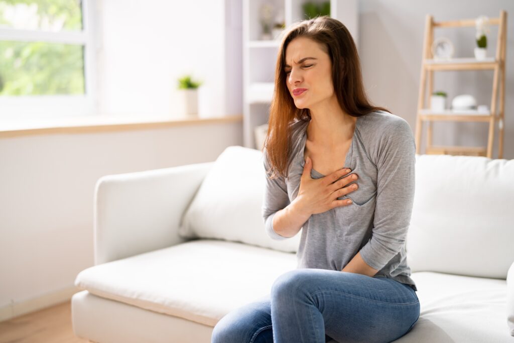 a woman holding her chest