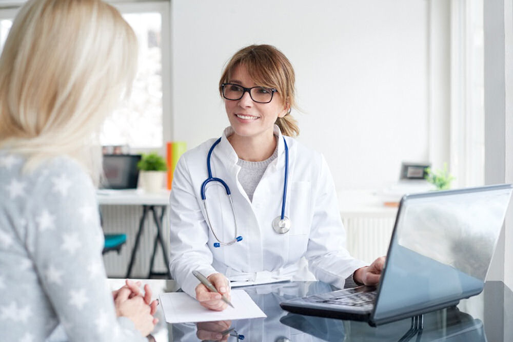 a woman speaking to a doctor