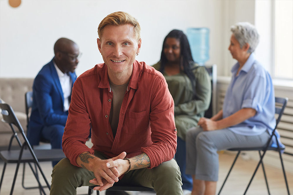 a-man-smiling-in-individual-therapy