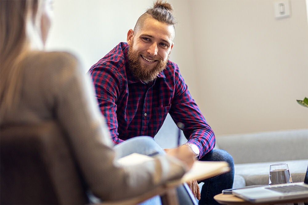 man smiling during individual therapy