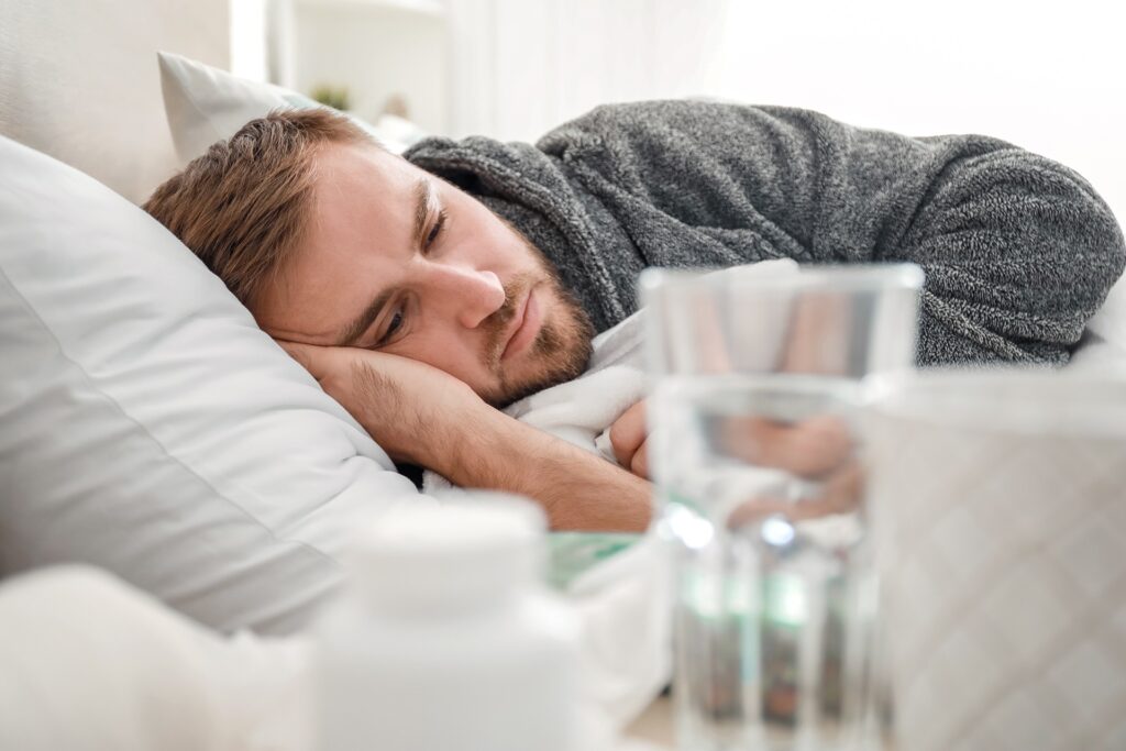 man laying in bed from cocaine use