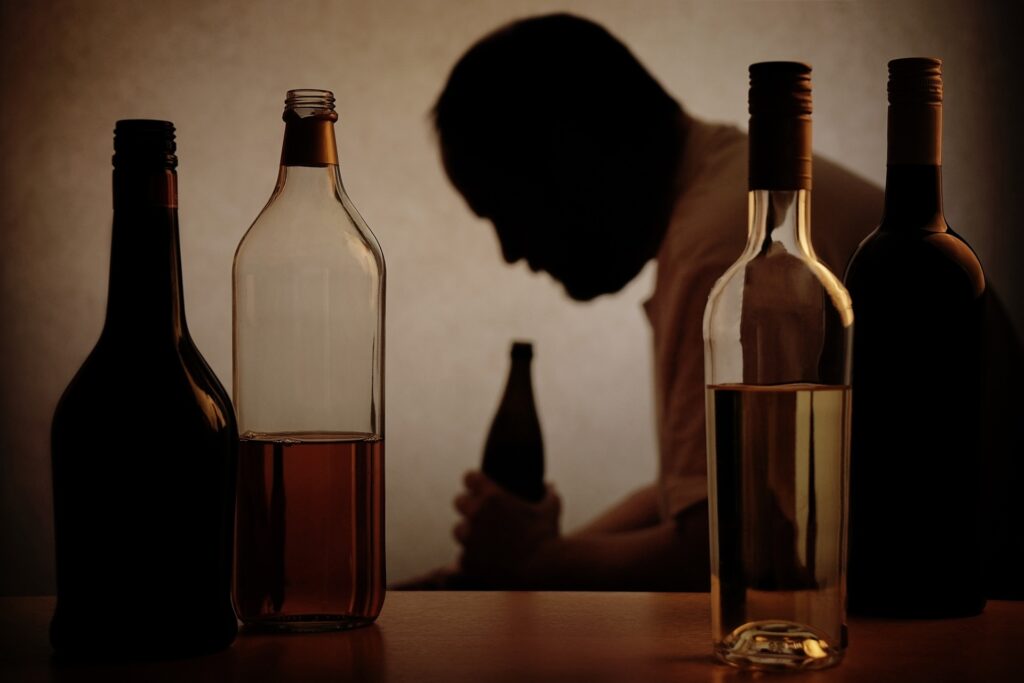 man surrounded by alcohol