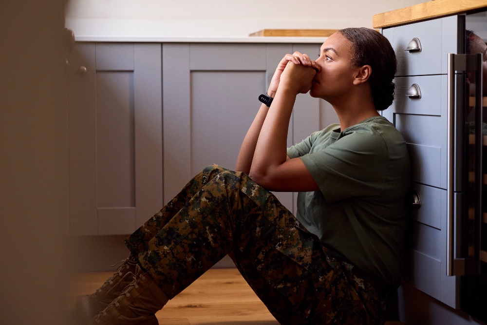 woman soldier sitting on kitchen floor with ptsd