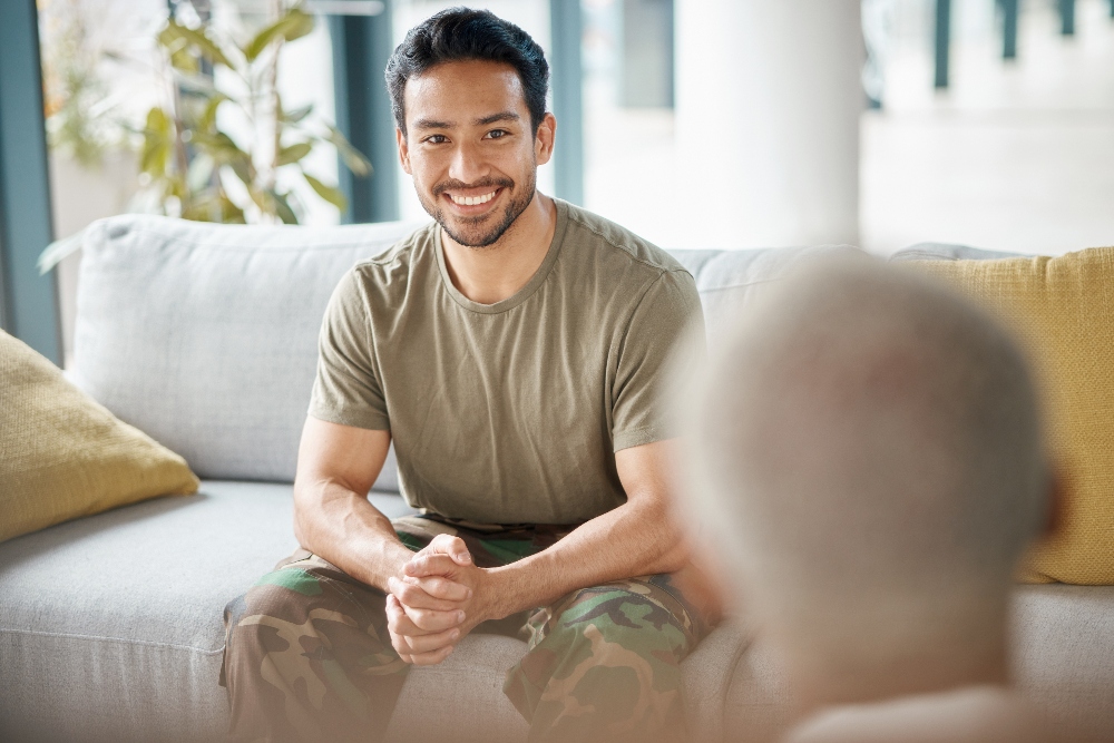 veteran man sitting on couch meeting with his therapist
