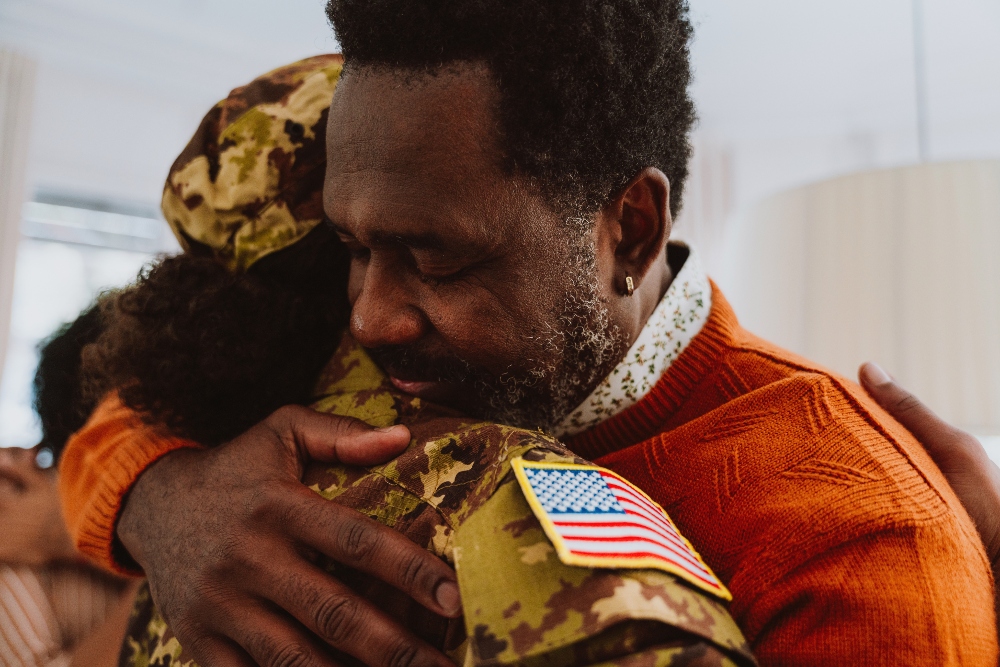 veteran woman hugging father after addiction rehab program