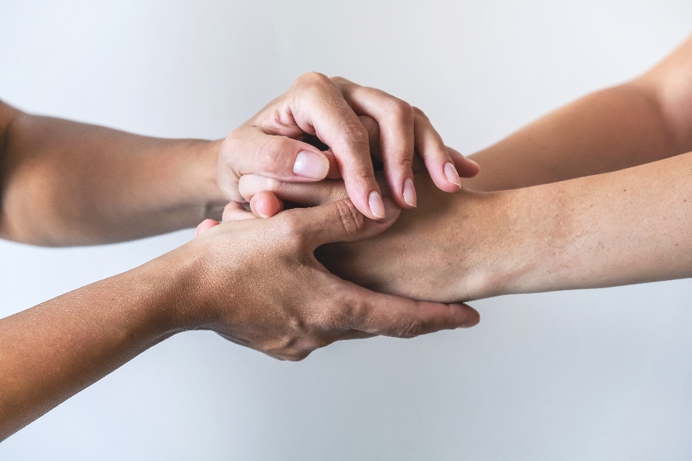 holding hands to support loved one